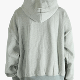 Gray zip-up hoodie worn by a person, showing the hoodie fit