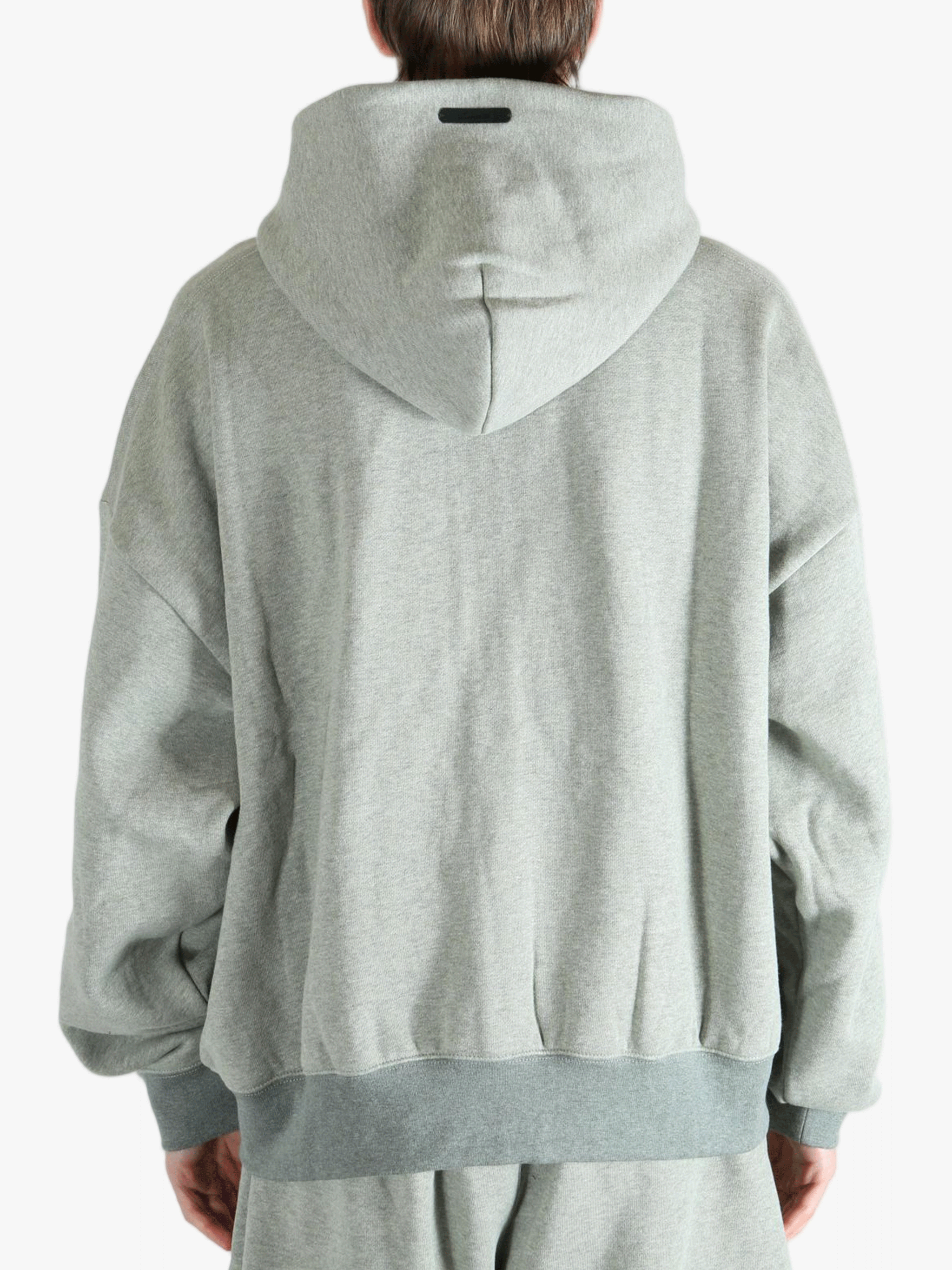 Gray zip-up hoodie worn by a person, showing the hoodie fit