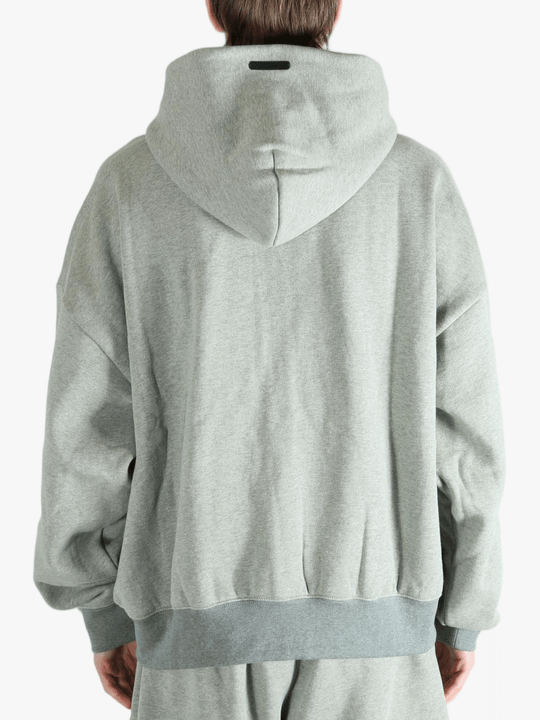 Gray zip-up hoodie worn by a person, showing the hoodie fit