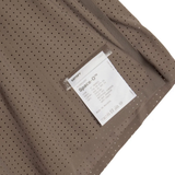 Close up of Brown shorts, showing texture of the 73% polyamide/ 27% elastane fabric