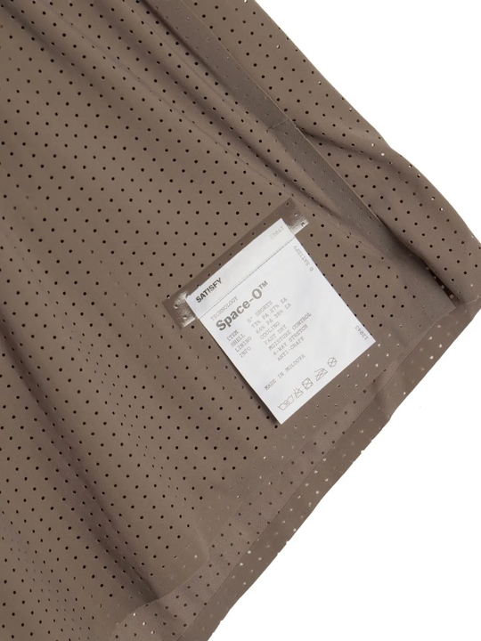 Close up of Brown shorts, showing texture of the 73% polyamide/ 27% elastane fabric