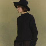 Navy knitwear worn by a person, showing the knitwear's fit