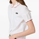 White shirt worn by a person, showing the shirt fit
