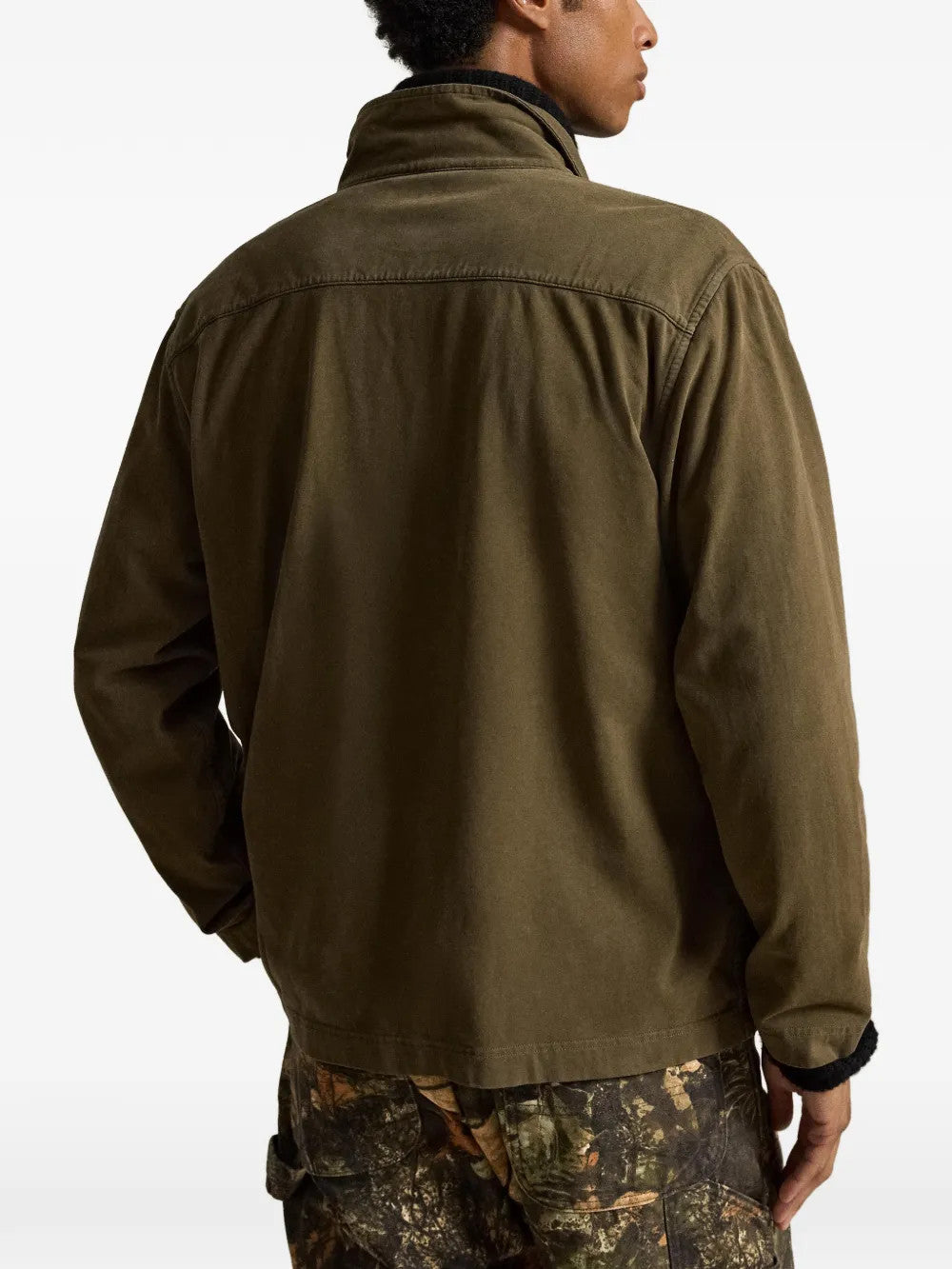 Green jacket worn by a person, showing the jacket fit