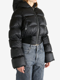 Black jacket worn by a person, showing the jacket fit