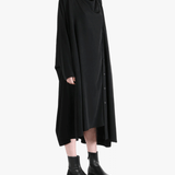 Black dress worn by a person, showing the dress' fit