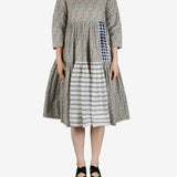 Grey dress worn by a person, showing the dress' fit