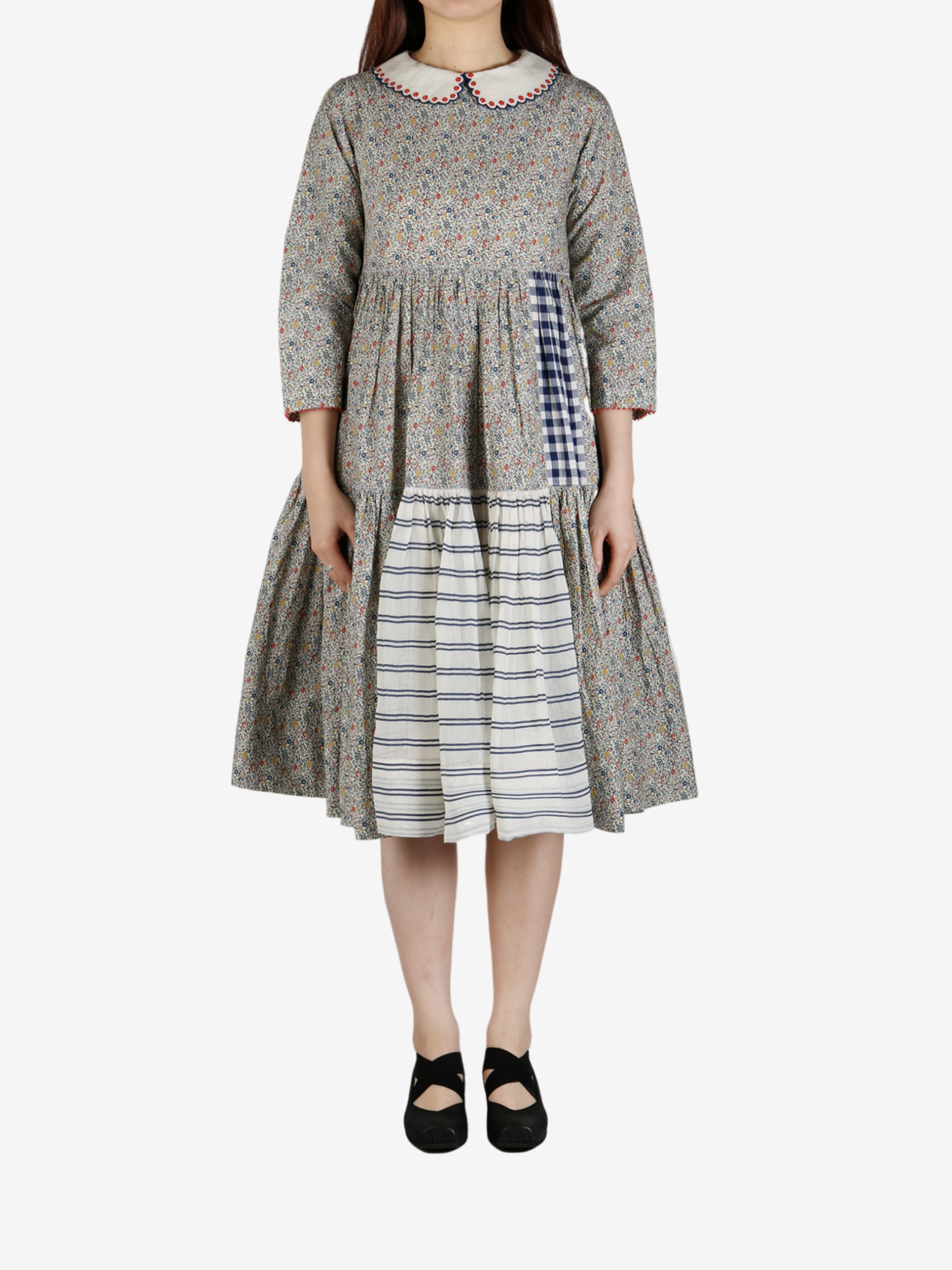 Grey dress worn by a person, showing the dress' fit