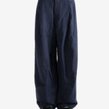 Navy pants worn by a person, showing the pants's fit