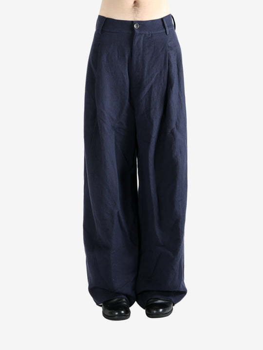 Navy pants worn by a person, showing the pants's fit