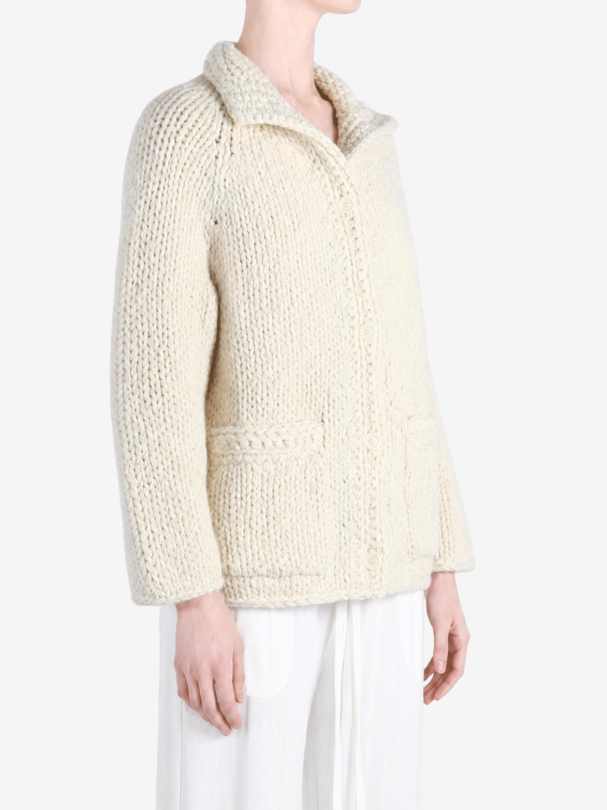 Tan knitwear worn by a person, showing the knitwear fit