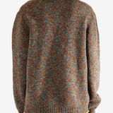 Brown knitwear worn by a person, showing the knitwear's fit