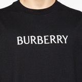 Close up of black t-shirts, showing texture of the cotton fabric