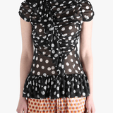 Black top worn by a person, showing the top‘s fit