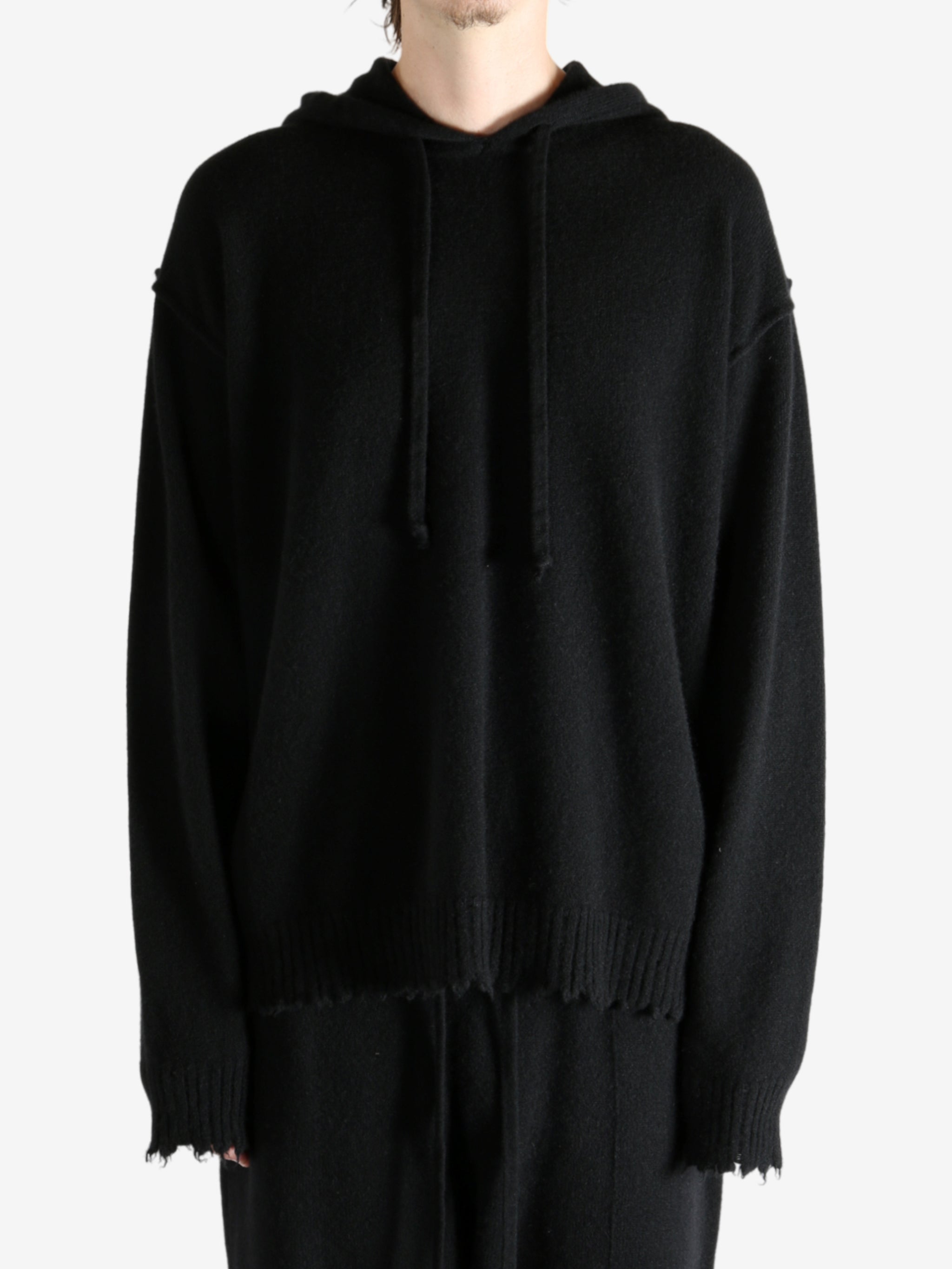 Black top worn by a person, showing the top's fit