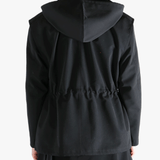 Black jacket worn by a person, showing the jacket fit