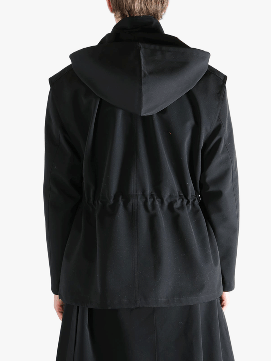 Black jacket worn by a person, showing the jacket fit