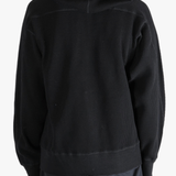 Black hoodie worn by a person, showing the hoodie's fit