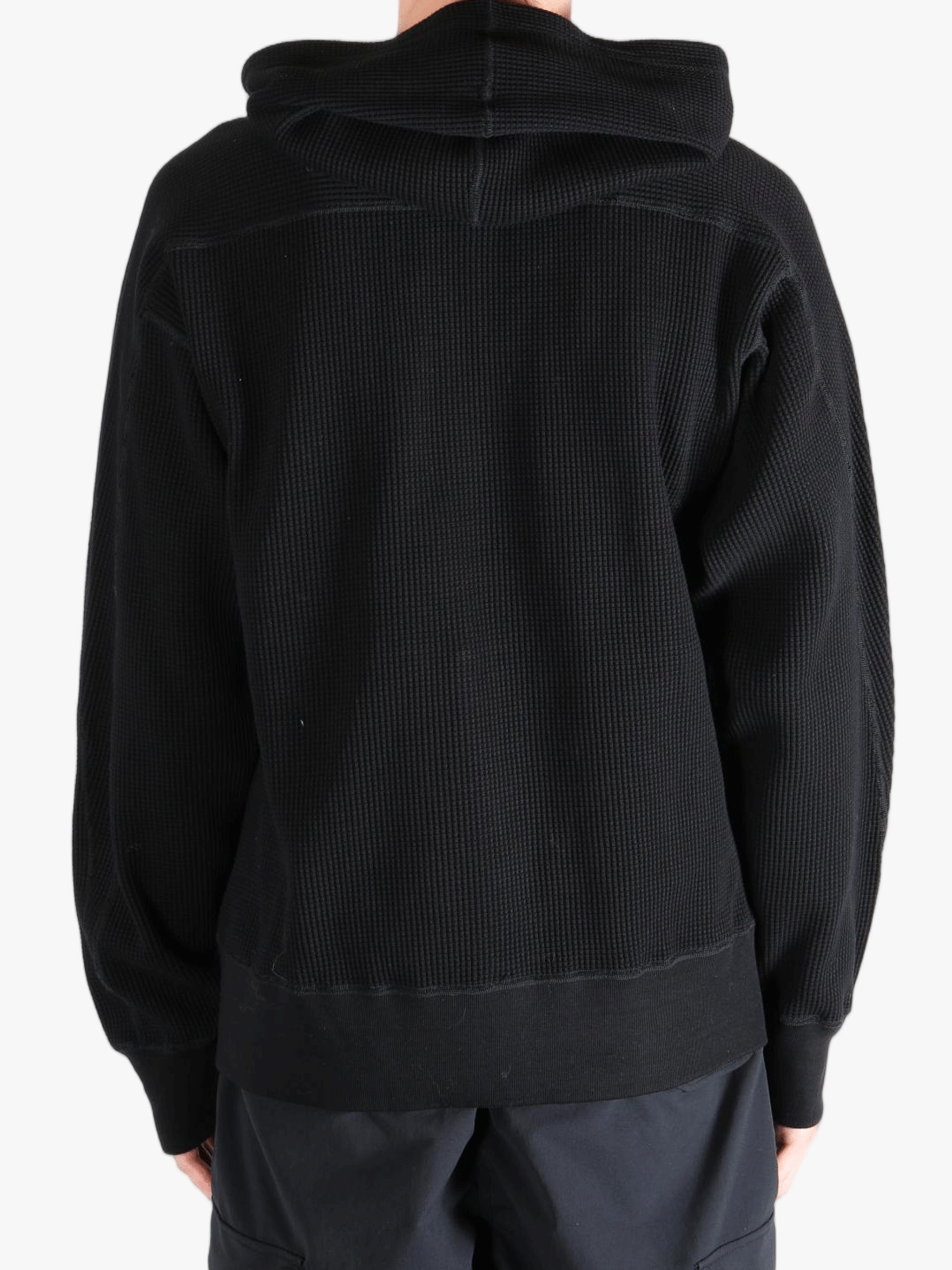 Black hoodie worn by a person, showing the hoodie's fit
