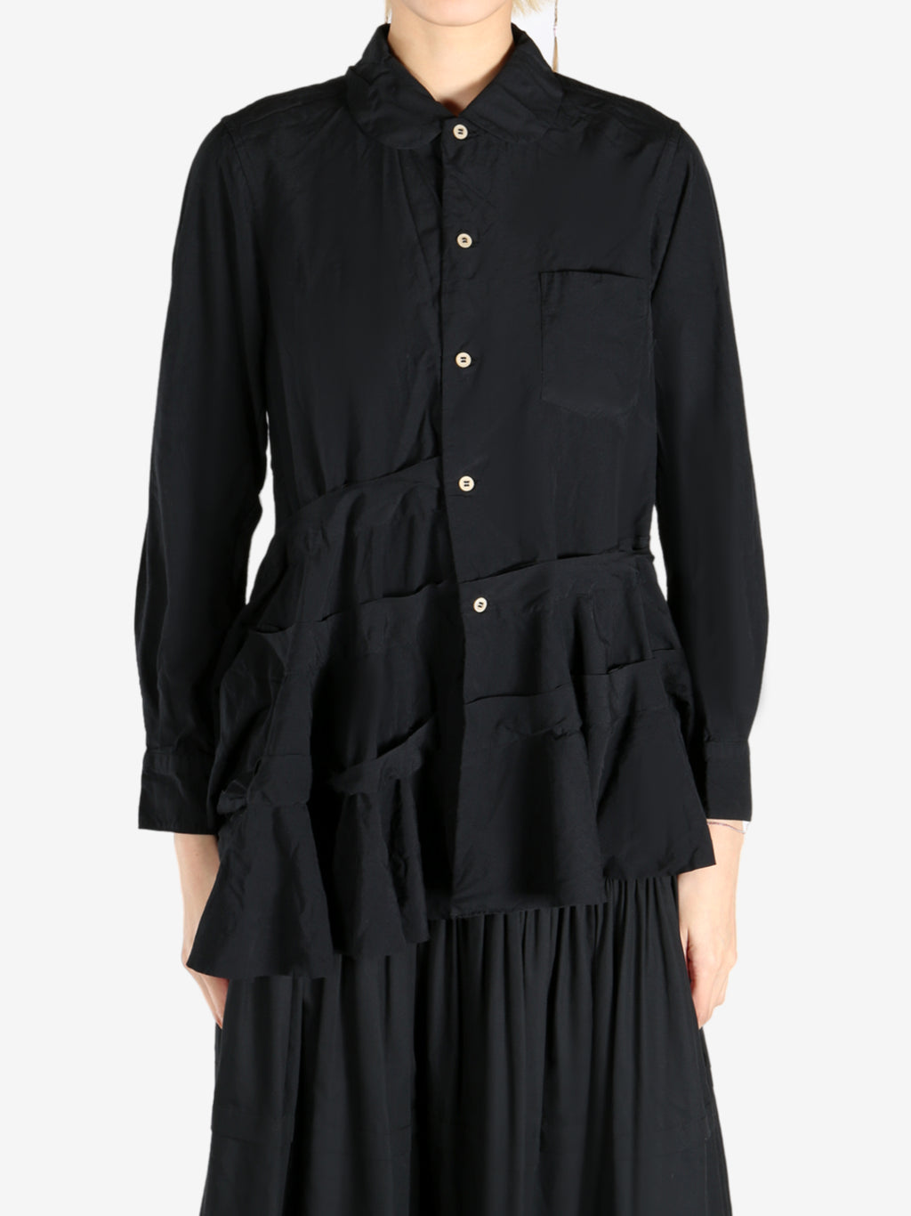 Black skirts worn by a person, showing the skirts fit