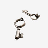 Close up of the grey earrings, showing texture of the silver fabric