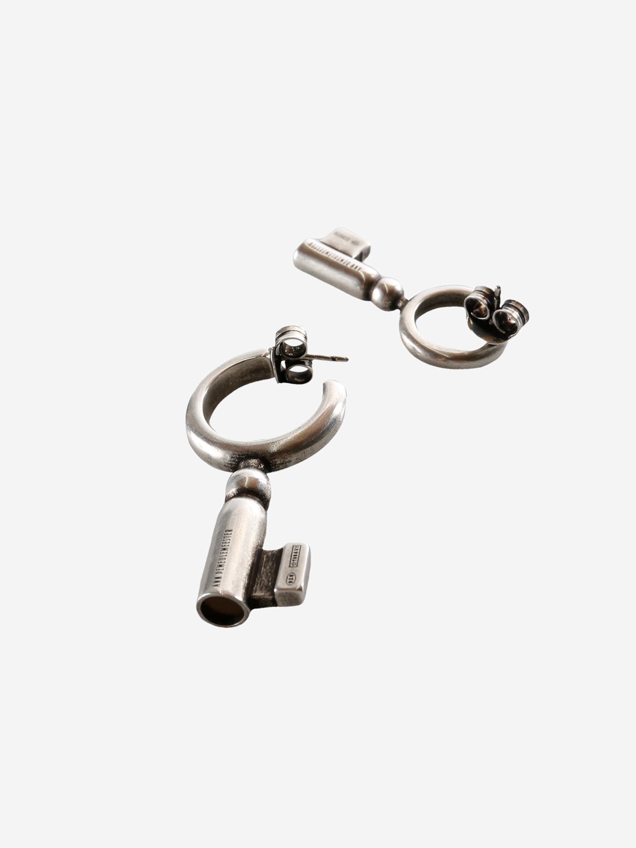 Close up of the grey earrings, showing texture of the silver fabric