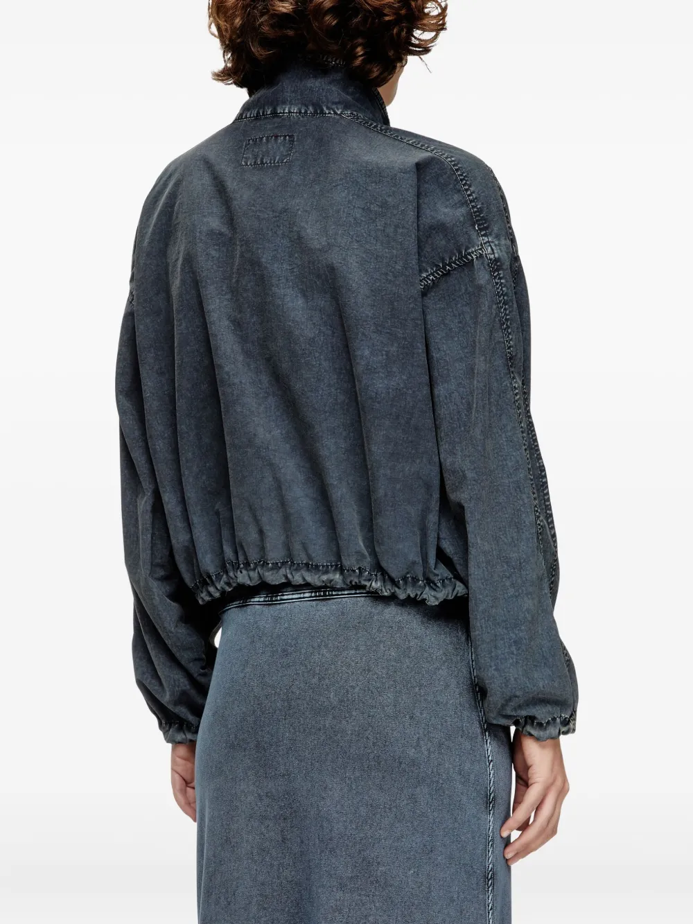 Black jacket worn by a person, showing the jacket's fit