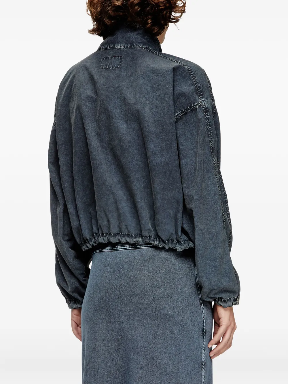 Black jacket worn by a person, showing the jacket's fit