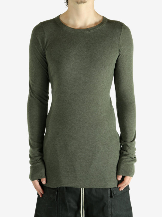 Green t-shirt worn by a person, showing the shirt's fit