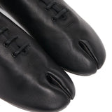 Close up of the black shoes, showing texture of the leather fabric