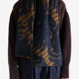 Navy scarf worn by a person, showing the scarf's fit