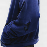 Close up of the blue hoodie, showing texture of the cotton fabric