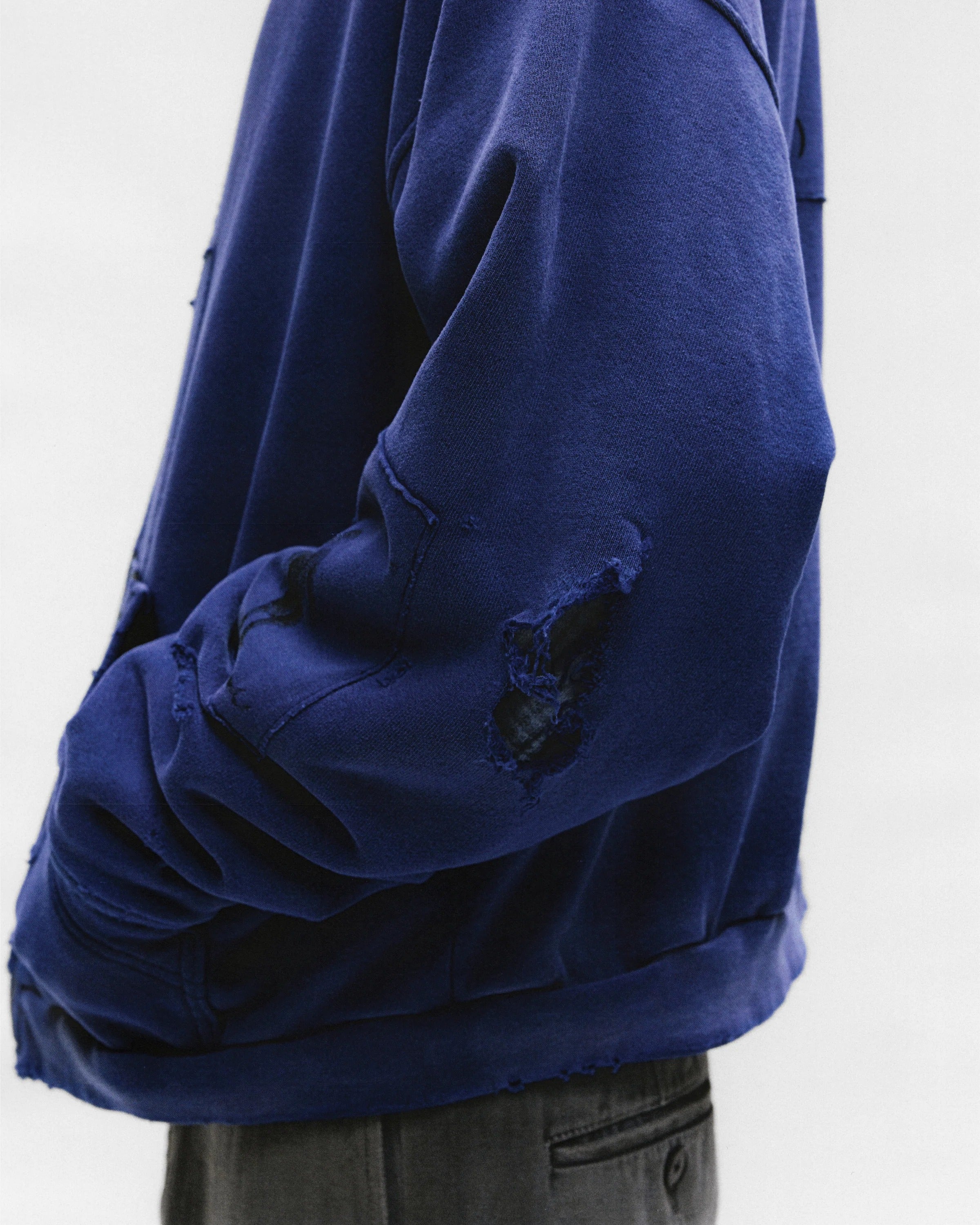 Close up of the blue hoodie, showing texture of the cotton fabric