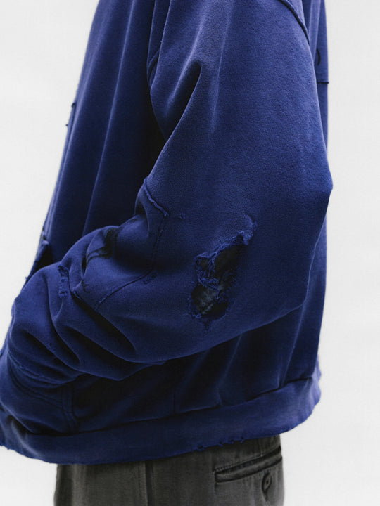 Close up of the blue hoodie, showing texture of the cotton fabric