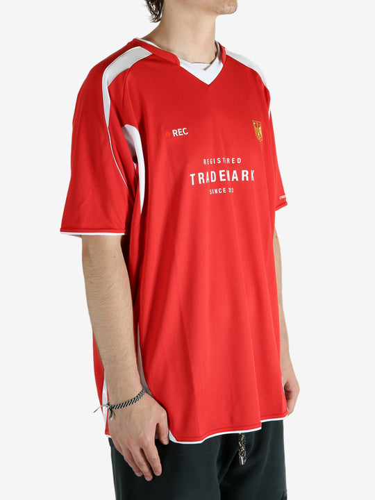 Red t-shirt worn by a person, showing the shirt's fit