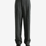 Black pants worn by a person, showing the pants fit