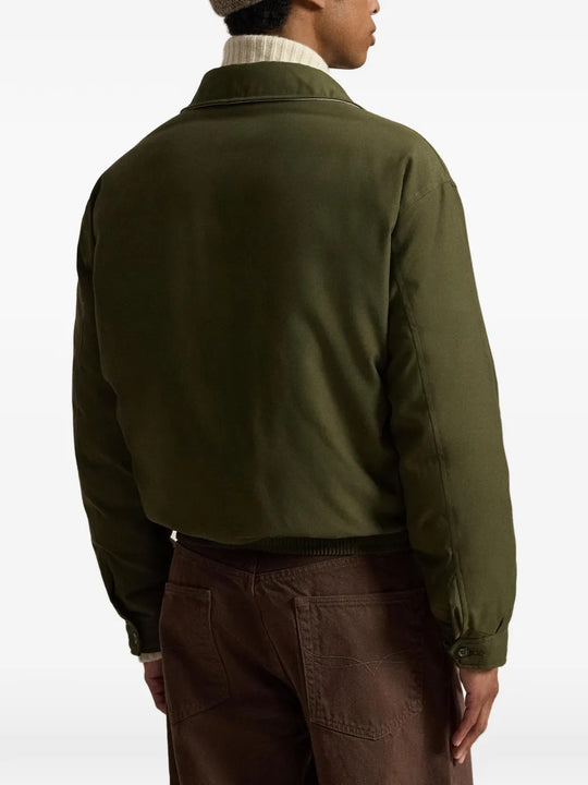 Green jacket worn by a person, showing the jacket fit
