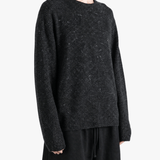 Black top worn by a person, showing the top fit