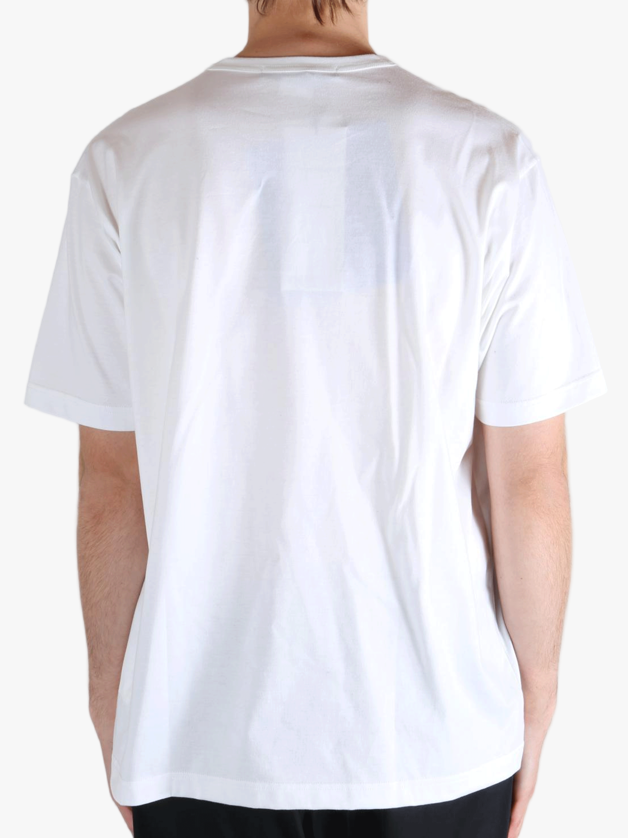 White t-shirt worn by a person, showing the t-shirt's fit