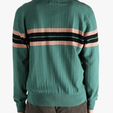 Green knitwear worn by a person, showing the knitwear's fit
