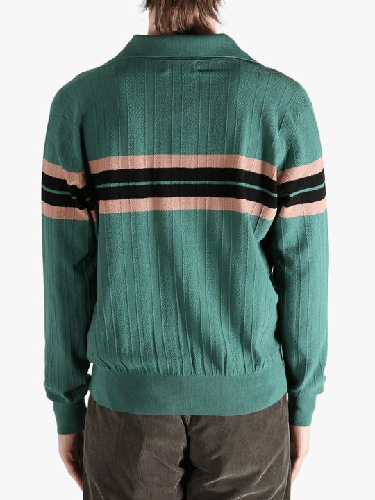 Green knitwear worn by a person, showing the knitwear's fit