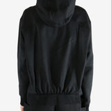 Black hoodie worn by a person, showing the hoodie's fit
