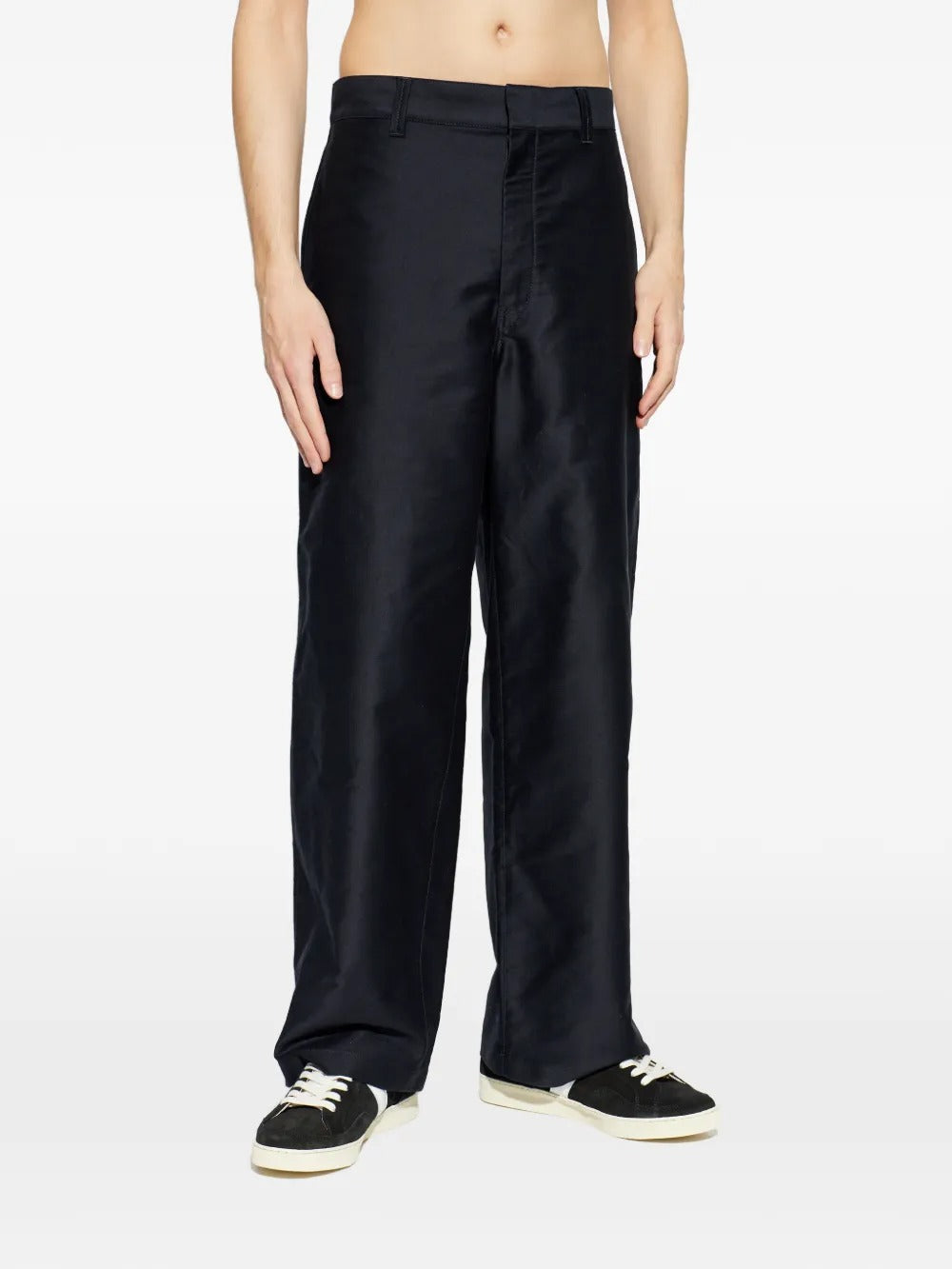 Black pants worn by a person, showing the pants fit