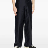 Black pants worn by a person, showing the pants fit