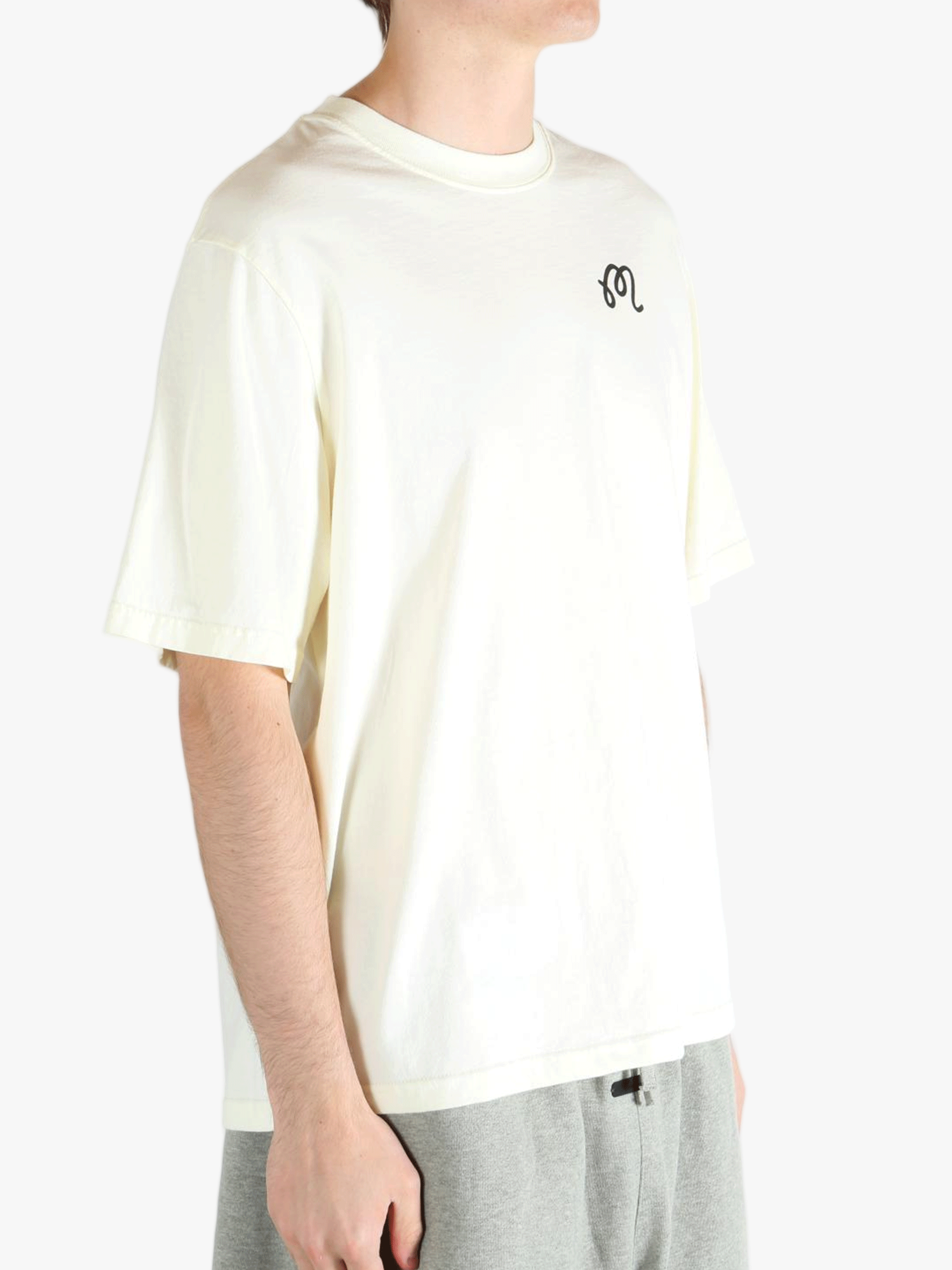 White t-shirt worn by a person, showing the shirt's fit