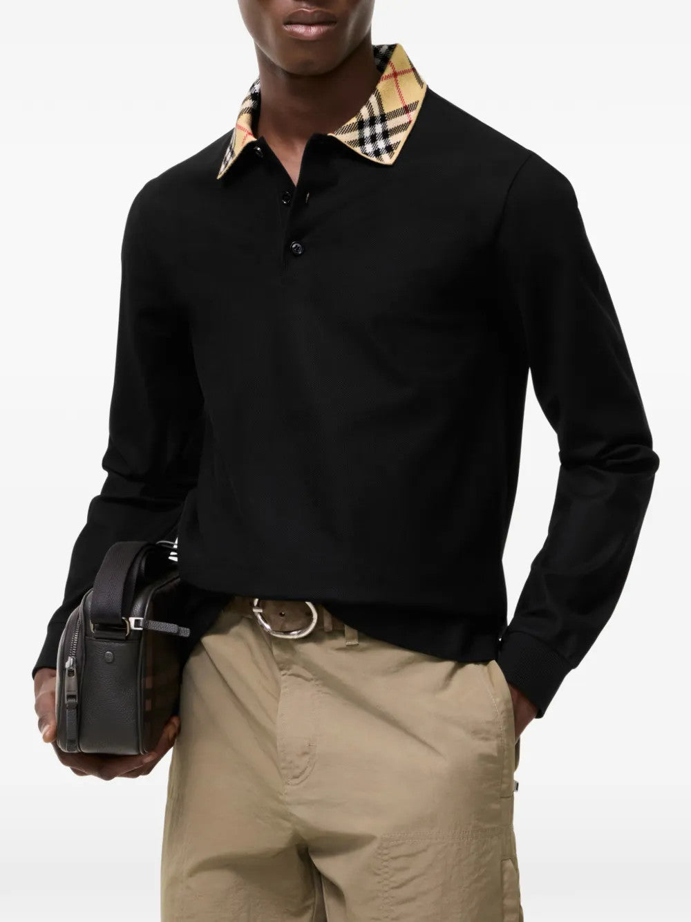 Black top worn by a person, showing the top fit