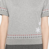 Grey t-shirt worn by a person, showing the t-shirt's fit