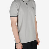 Grey shirt worn by a person, showing the shirt's fit 