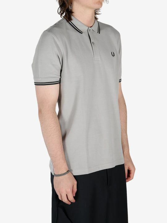 Grey shirt worn by a person, showing the shirt's fit 