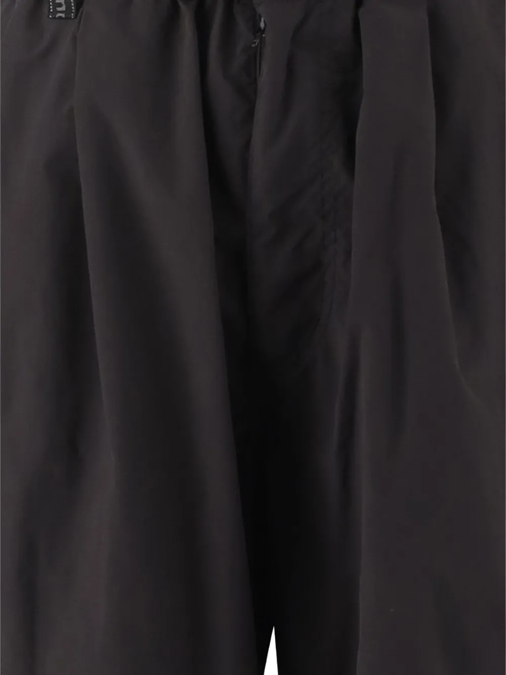 Close up of black pants, showing the fabric of sythenic material
